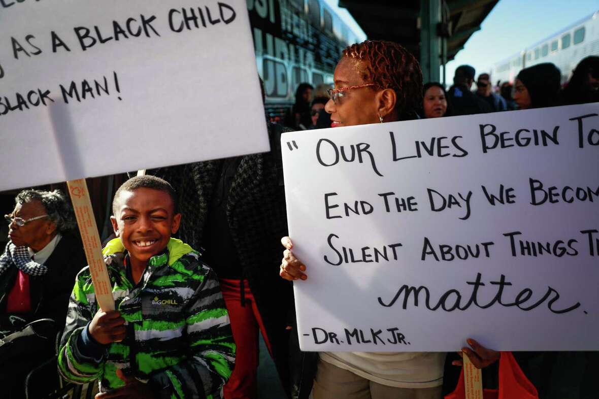 Clarissa Flippin (right) and grandson Domonic Hampton, (left) walk from the Caltrain to participate in the MLK walk in San Francisco, 2019.