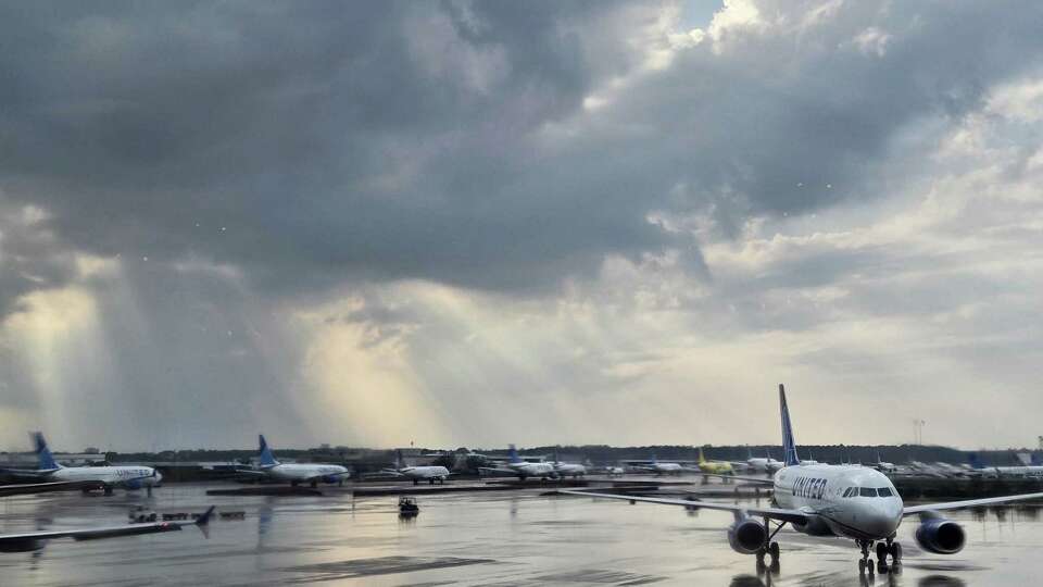 Aircraft wait as storms move through the area Saturday, Dec. 28, 2024, at George Bush Intercontinental Airport in Houston. Repeated lightning strikes led to ground stops, according to airline staff.