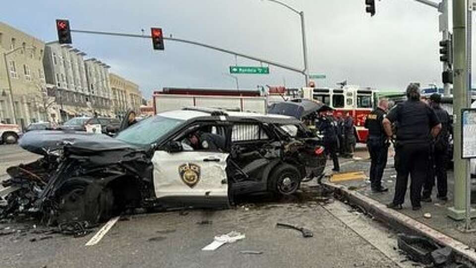 Authorities investigate a car crash at Seventh Street and Mandela Parkway in Oakland that resulted in three BART police officers and the driver of another vehicle being taken to a hospital on Saturday, Dec. 28, 2024.