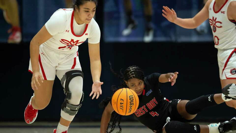 St. Mary's Gaels guard Zeryhia Aokuso (24) scoops up a loose ball in front of California State East Bay Pioneers forward Jaela Richardson (4) during the first quarter of a women’s NCAA college basketball game on Monday, Dec. 18, 2023 in Moraga, Calif.