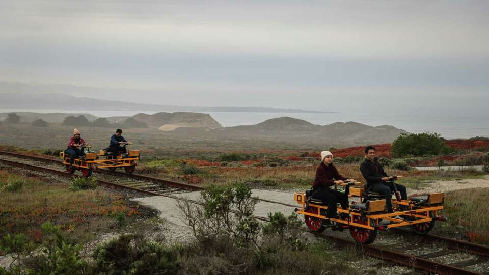 (L-r) Visitors Abi Subramanian, Hari Sundar, Sriru Srivatsav and Suryaa Raman take a guided handcar tour on historic train tracks in Marina, Calif., on Thursday, Dec. 26, 2024. The company Handcar Tours is now fighting for its survival after its lease was not renewed -- which the company said was in retaliation for opposing a bus line that would have resulted in tearing up the rails.