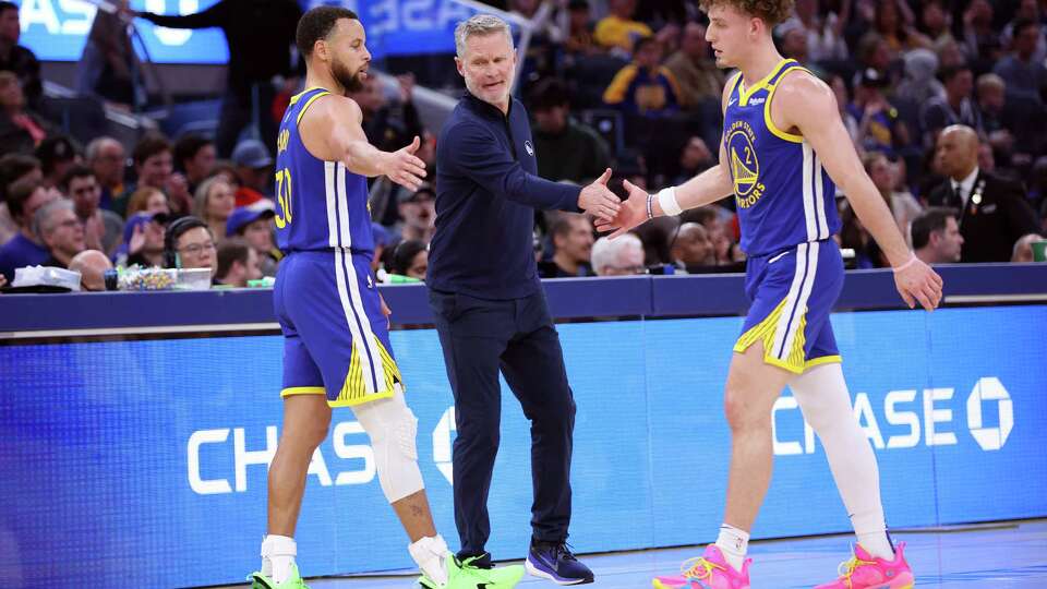 Golden State Warriors’ head coach Steve Kerr and Stephen Curry slap hands with Brandin Podziemski during Indiana Pacers’ 111-105 win in NBA game at Chase Center in San Francisco on Monday, December 23, 2024.