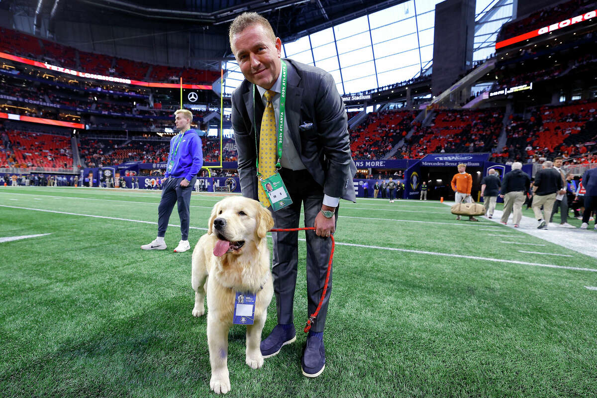 ESPN commentator Kirk Herbstreit poses with his dog Peter prior to the 2024 SEC Championship between the Texas Longhorns and the Georgia Bulldogs at Mercedes-Benz Stadium on Dec. 7, 2024 in Atlanta.