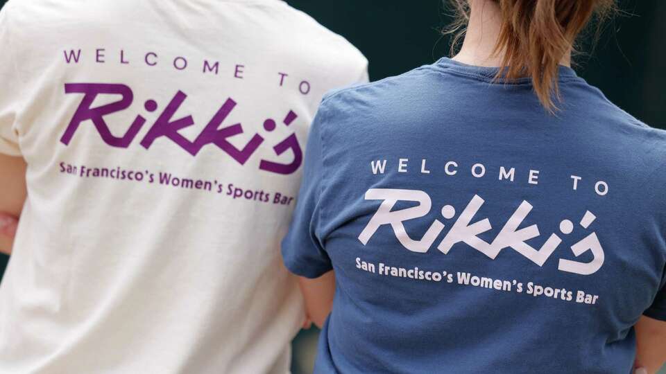 Sara Yergovich, left to right, and Danielle Thoe, owners Rikki's Bar, a women's sports bar coming to San Francisco, wear new shirts for their bar Rikki’s as they stand for a portrait at Rikki Streicher Field on Thursday, August 29`, 2024 in San Francisco, Calif. Rikki’s is named in honor of Rikki Streicher, San Francisco business owner, leader in San Francisco LGBT movement and a creator of the Federation of Gay Games.