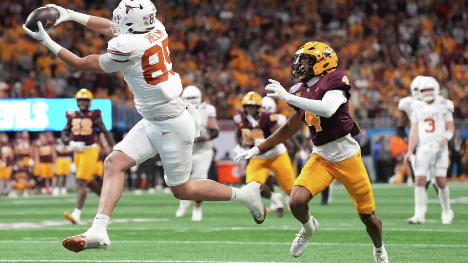 Texas tight end Gunnar Helm (85) catches a 25-yard touchdown pass in front of Arizona State defensive back Myles Rowser (4) in double overtime of the Peach Bowl during a NCAA college football playoff quarterfinal game on Wednesday, Jan. 1, 2025, in Atlanta. Texas defeated Arizona State 39-31 in double overtime.