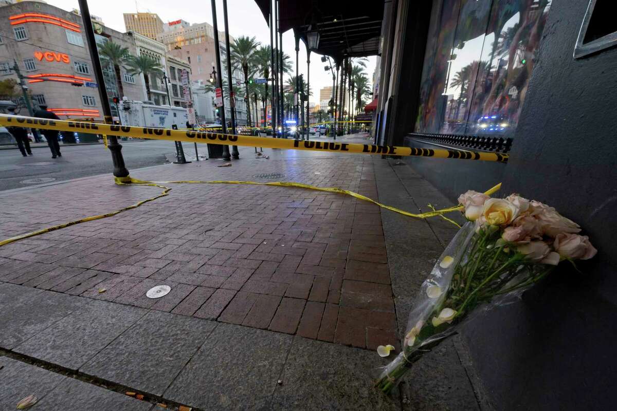 A bouquet of flowers stands at the intersection of Bourbon Street and Canal Street during the investigation after a pickup truck rammed into a crowd of revelers early on New Year's Day, Wednesday, Jan. 1, 2025, in New Orleans.