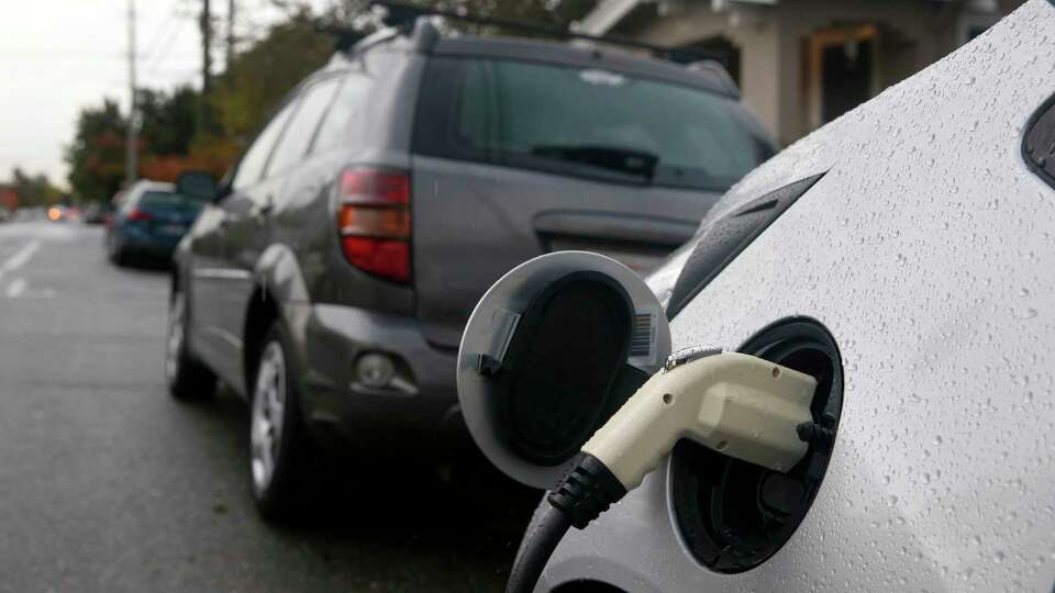 A curbside charging station for Amy Hale's electric car is installed in front of her home in Berkeley, Calif. on Wednesday, Nov. 15, 2017. Amy Hale and her fiancé Bernhard Haux are participating in a pilot project by the city of Berkeley which is permitting a limited number of curbside charging stations for residents enrolled in the program.