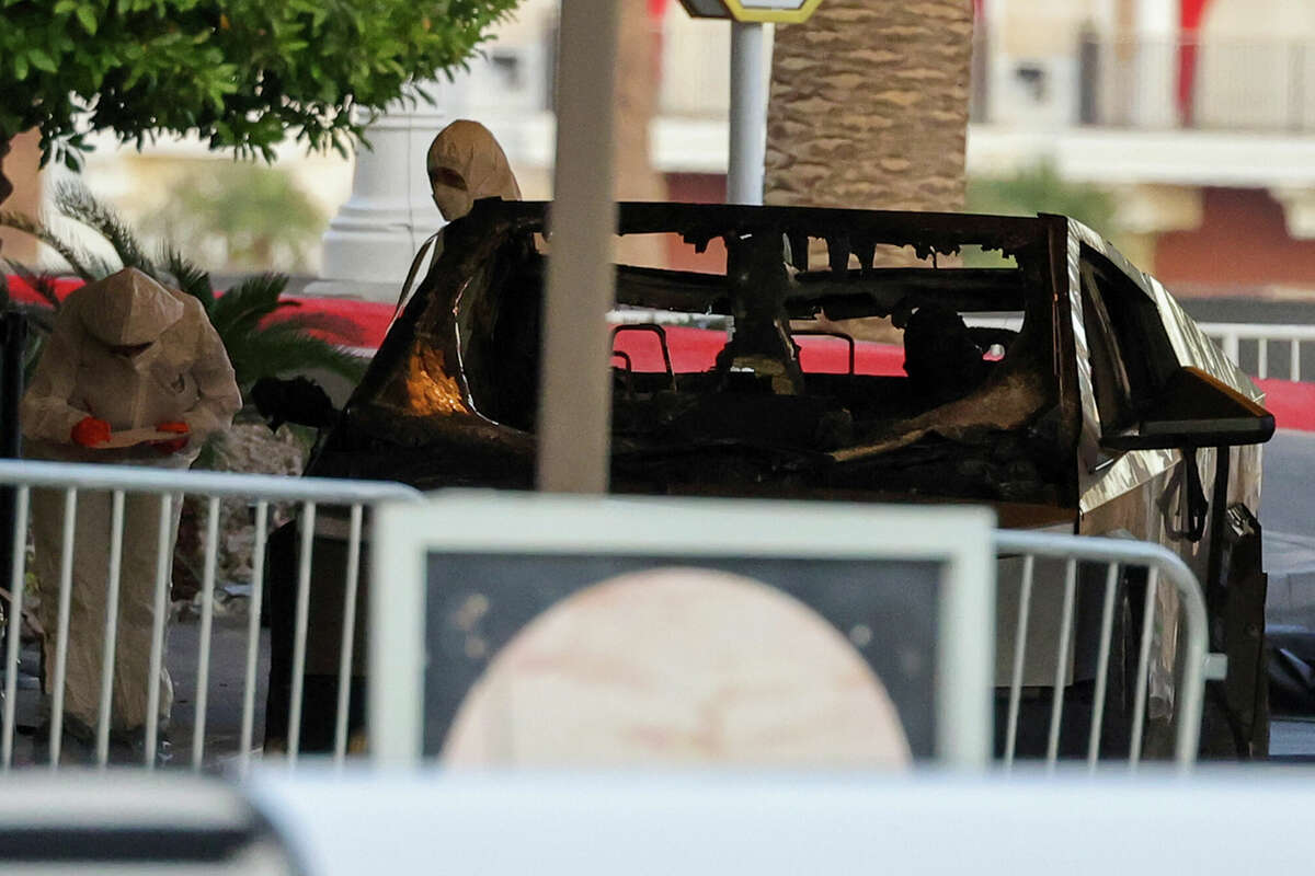 First responders wearing Hazmat gear investigate a Tesla Cybertruck that exploded in front of the entrance to the Trump International Hotel & Tower Las Vegas on January 01, 2025 in Las Vegas, Nevada. A person who was in the vehicle died and seven people were injured. Authorities are investigating the incident as a possible terrorist attack and are looking for a possible connection to a deadly crash in New Orleans. 