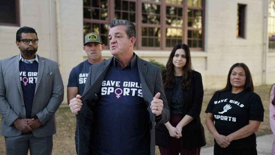 Riverside, CA - December 19: From left in background: Daniel Silvas, community leader, Lexit director of Riverside County, Ryan Starling, father of Taylor, a junior at Martin Luther King High School, plaintiff in lawsuits regarding a transgender athlete, Julianne Fleischer, legal counsel, Assemblymember Leticia Castillo, listen to Robert Tyler, center, president and general counsel of Advocates for Faith & Freedom, speak at a news conference 'about the preferential treatment biological boys are receiving' and calling for the resignation of Riverside Unified Superintendent Renee Hill and brought it up during community comments discussing the issue of transgender athletes competing in girls high school sports at the Riverside Unified School District meeting Thursday, Dec. 19, 2024.