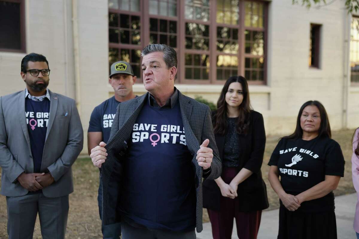 Riverside, CA - December 19: From left in background: Daniel Silvas, community leader, Lexit director of Riverside County, Ryan Starling, father of Taylor, a junior at Martin Luther King High School, plaintiff in lawsuits regarding a transgender athlete, Julianne Fleischer, legal counsel, Assemblymember Leticia Castillo, listen to Robert Tyler, center, president and general counsel of Advocates for Faith & Freedom, speak at a news conference 'about the preferential treatment biological boys are receiving' and calling for the resignation of Riverside Unified Superintendent Renee Hill and brought it up during community comments discussing the issue of transgender athletes competing in girls high school sports at the Riverside Unified School District meeting Thursday, Dec. 19, 2024.