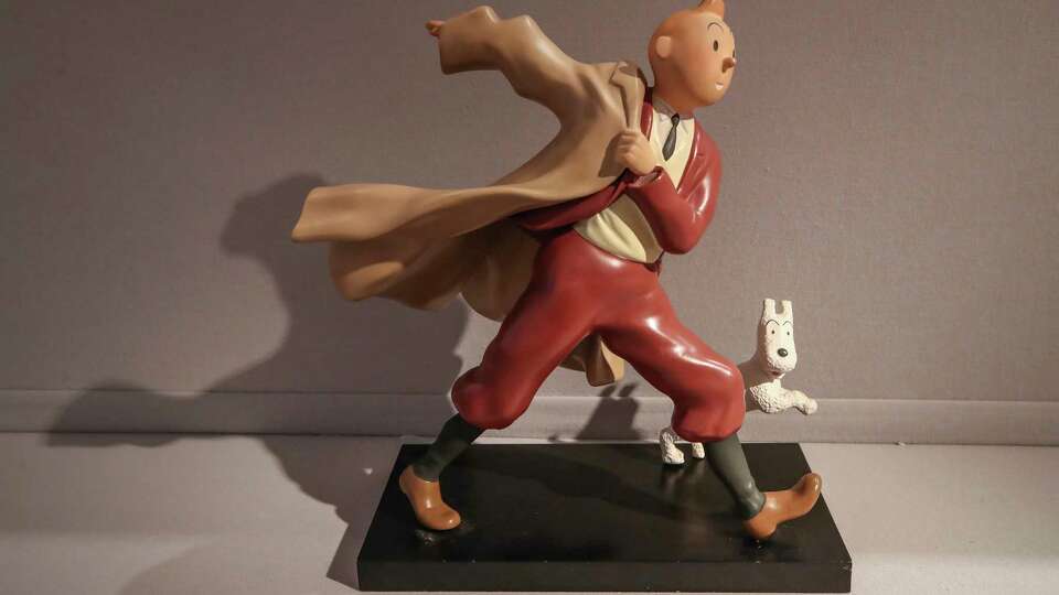 A 1988 polychrome resin sculpture of the comic character Tintin and his dog snowy from the 1941 'The Crab with the Golden Claws' album drawn by Belgian creator Herge is displayed at the Artcurial auction house in Paris, Wednesday, Jan. 13, 2021. The art work with an estimates value of 400 to 900 euros (US $ 486 to 1095), is going on sale Thursday.