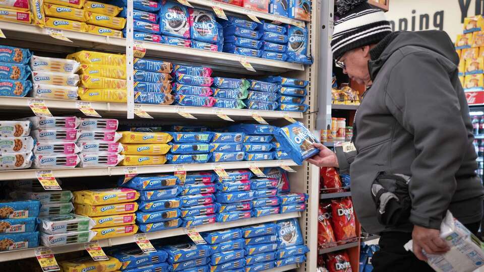 CHICAGO, ILLINOIS - DECEMBER 11: A customer shops for cookies manufactured by Mondelez at a grocery store on December 11, 2024 in Chicago, Illinois. Mondelez is one of several companies named in a lawsuit that accuses major food manufacturers of marketing ultra-processed and addictive foods to children.