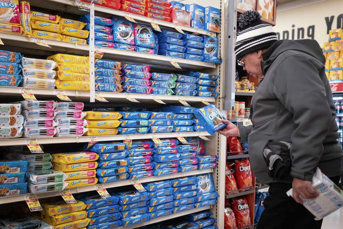 CHICAGO, ILLINOIS - DECEMBER 11: A customer shops for cookies manufactured by Mondelez at a grocery store on December 11, 2024 in Chicago, Illinois. Mondelez is one of several companies named in a lawsuit that accuses major food manufacturers of marketing ultra-processed and addictive foods to children.