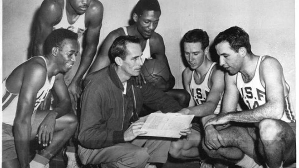 Univ. of San Francisco won the top United Press college basketball title in the nation 2/7 from Kentucky. The Dons, exponents of 'old-fashoned' possession basketball and tight defense have 16 wins against one loss. Coach Phil Woolpert confers with his top players: (L-R) Hal Perry, guard; K.C.Jones, guard; Bill Russell, center; Stan Buchanan, forward; and Jerry Mullen, forward.