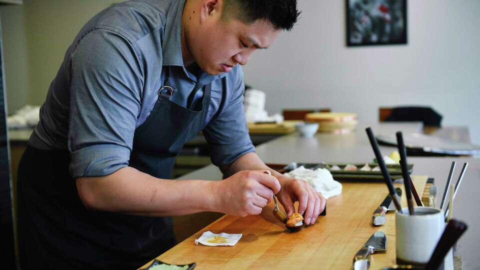 Chef and co-owner Geoffrey Lee prepares sea urchin from Tsukiji Market, at Ju-Ni in San Francisco, CA, on Tuesday May 16, 2017.