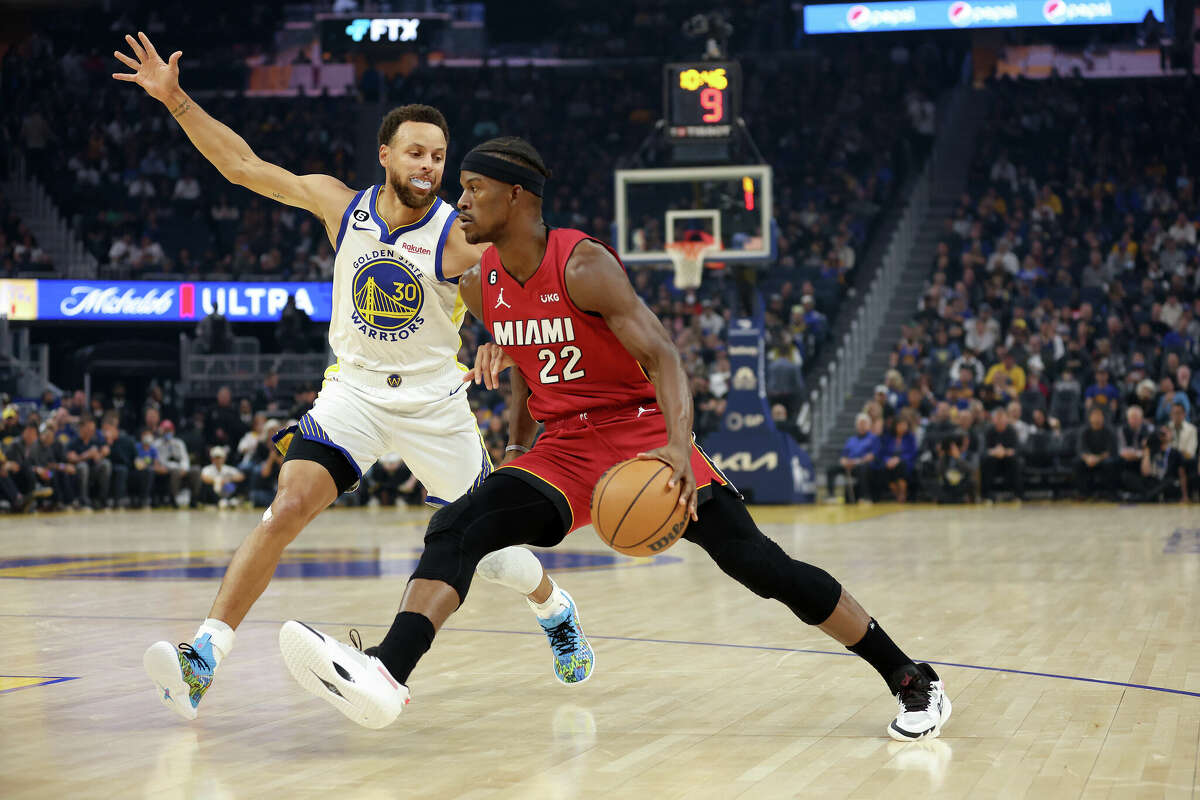 Jimmy Butler of the Miami Heat is guarded by Stephen Curry of the Golden State Warriors at Chase Center on October 27, 2022 in San Francisco, California.