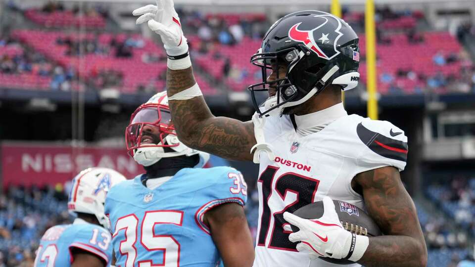 Houston Texans wide receiver Nico Collins (12) reacts after scoring a two-yard touchdown pass by quarterback C.J. Stroud during the first half of an NFL football game Sunday, Jan. 5, 2025, in Nashville, Tenn.