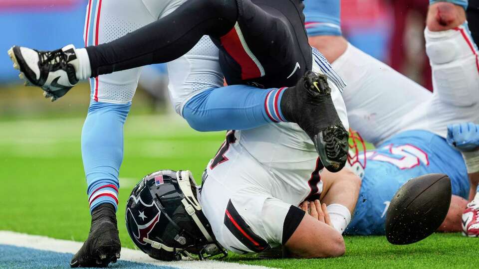 Houston Texans quarterback Davis Mills (10) lands on the turf after being tackled by Tennessee Titans linebacker Luke Gifford during the second half of an NFL football game Sunday, Jan. 5, 2025, in Nashville, Tenn. Mills was ruled down by contact and not ruled a fumble.