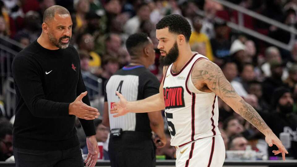 Houston Rockets guard Fred VanVleet, right, gets a high-five from head coach Ime Udoka during the second half of an NBA basketball game, Sunday, Jan. 5, 2025, at Toyota Center.