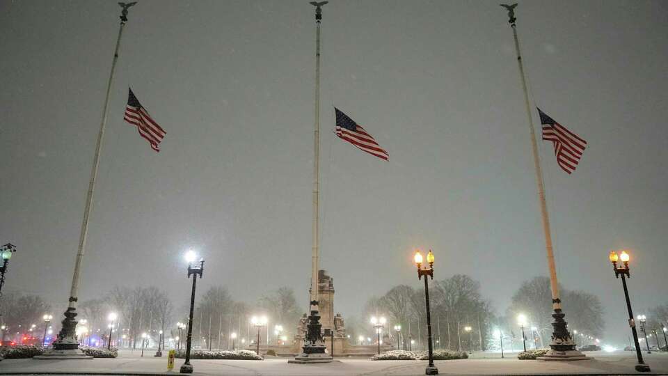 Flags fly at half-staff in memorial to former President Jimmy Carter during a winter snow storm at Union Station in Washington, Monday, Jan. 6, 2025. Carter died at age 100.