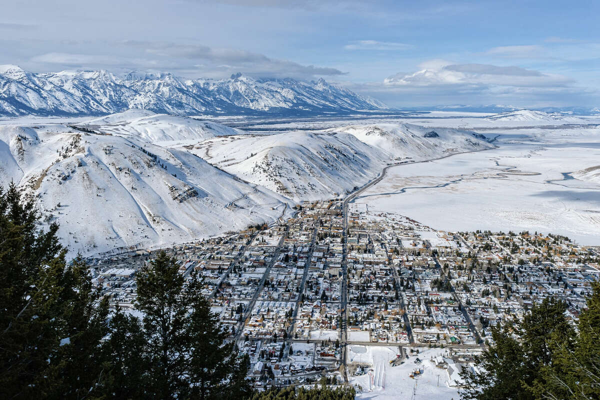 Jackson Hole, Wyoming, is part of the Grand Teton Valley, surrounded by the Rocky Mountains and wild forested land.