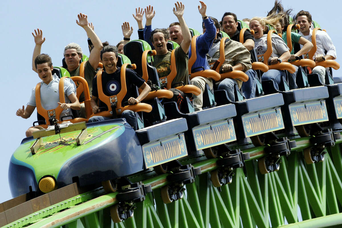 Riders raise their arms as they travel the 'Kingda Ka' roller coaster 19 May, 2005, at Six Flags amusement park in Jackson, New Jersey. The roller coaster is billed as the tallest at 456 feet (139 meters) and fastest, 128 mph (205 kph) on the Earth.