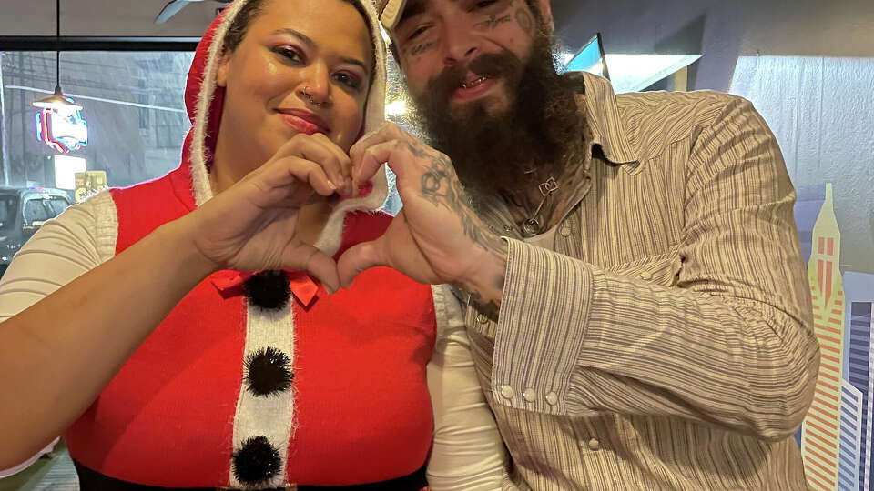 Post Malone took a picture with Houston bartender Renee Brown before she noticed he tipped her $20,000. Photos Courtesy of The Railyard