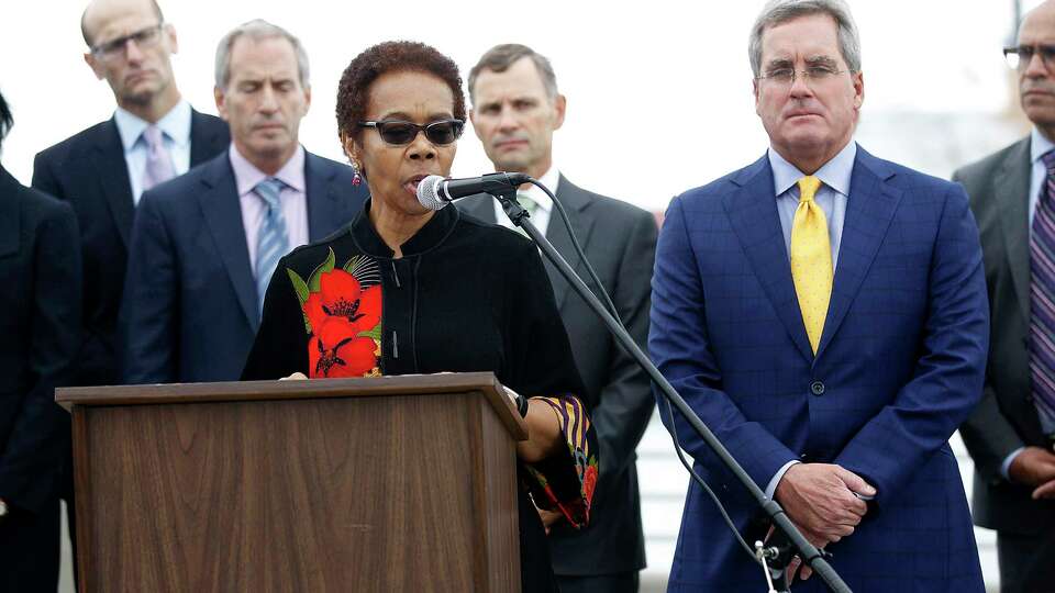 Oakland city attorney Barbara Parker (at podium) and SF city attorney Dennis Herrera (right) announce they had filed separate lawsuits on behalf of their respective cities against the five-largest investor-owned producers of fossil fuels on the Embardadero at Brannan streets on Wednesday, September 20, 2017, in San Francisco, Calif.