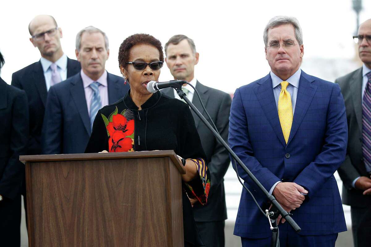 Oakland city attorney Barbara Parker (at podium) and SF city attorney Dennis Herrera (right) announce they had filed separate lawsuits on behalf of their respective cities against the five-largest investor-owned producers of fossil fuels on the Embardadero at Brannan streets on Wednesday, September 20, 2017, in San Francisco, Calif.