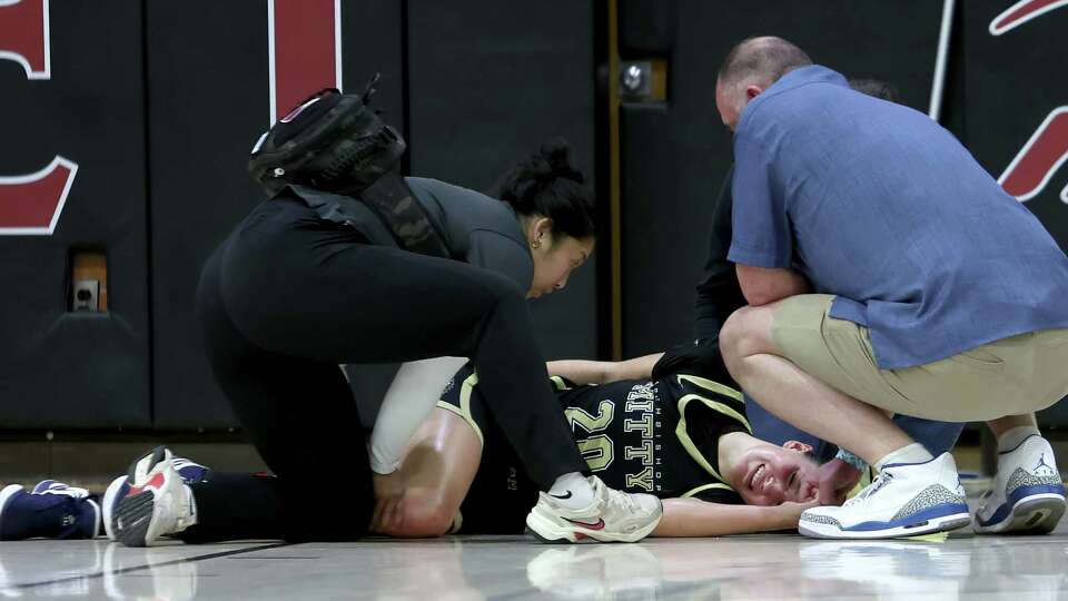 Mitty junior McKenna Woliczko clutches her right knee after suffering an injury in Saturday's Sabrina Ionescu Showcase.