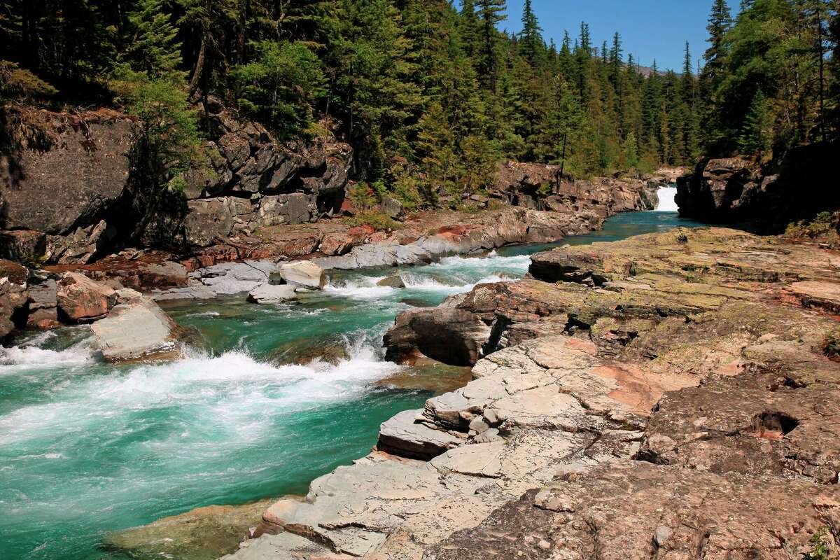 Whitewater cascades along McDonald Creek in Glacier National Park in early summer.