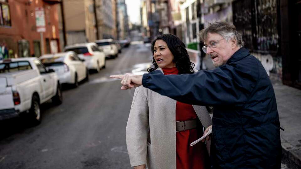 Outgoing Mayor London Breed and retiring Chronicle reporter Kevin Fagan are seen at the corner of Willow and Larkin Street during a walk though the Tenderloin neighborhood of San Francisco, Wednesday, Dec. 18, 2024.