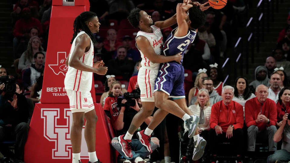 Houston guard L.J. Cryer, center, fouls TCU guard RJ Jones (24) during the first half of an NCAA college basketball game in Houston, Monday, Jan. 6, 2025. (AP Photo/Ashley Landis)