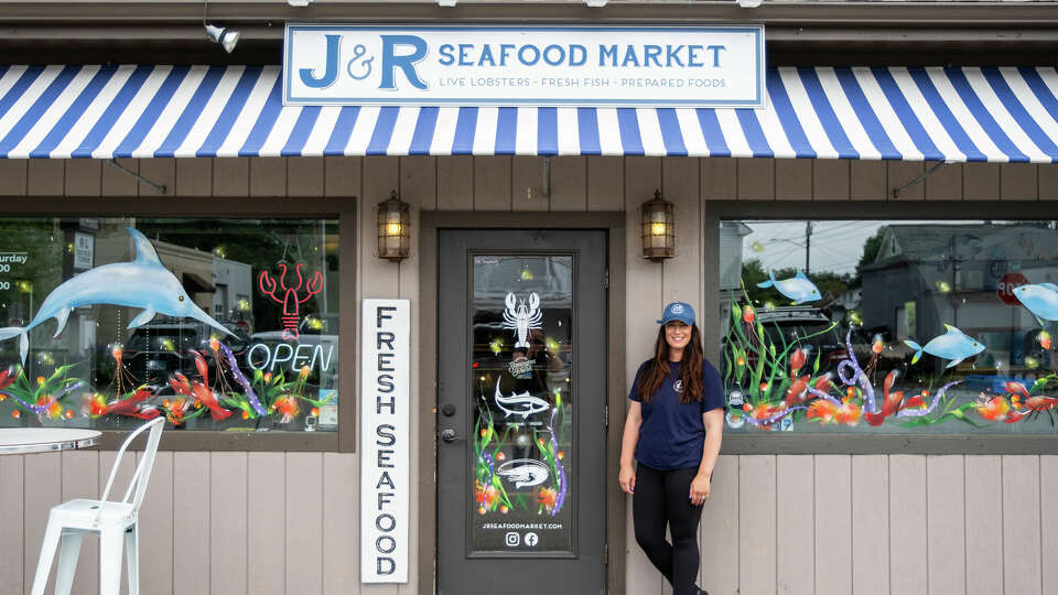 Allison Cole, the owner and operator of J&R Seafood Market, stands in front of her business located in Mystic. Cole plans to open a new business, Off The Hook, in early spring.