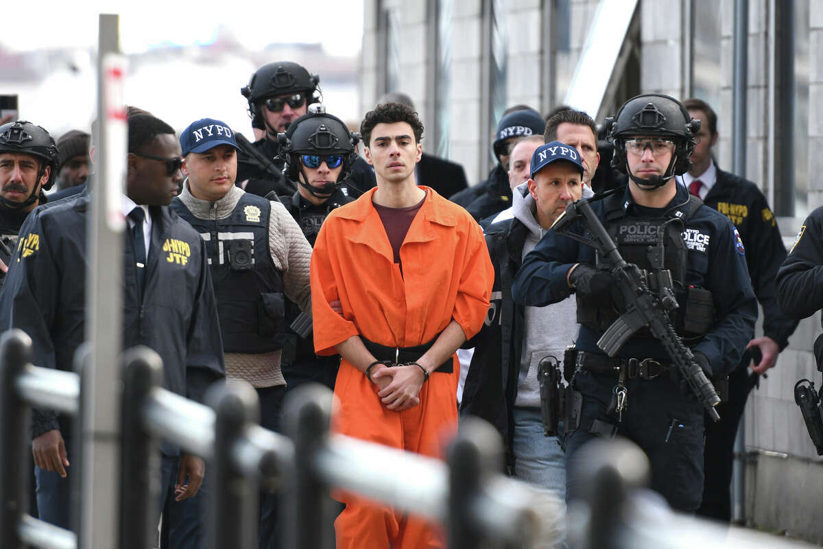 Luigi Mangione, a suspect in the fatal shooting of UnitedHealthcare CEO Brian Thompson, is escorted by police, Thursday, Dec. 19, 2024, in New York.  