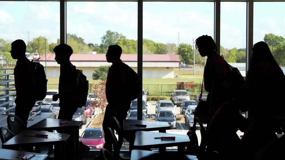 Audrey H. Lawson Middle School students walk in file to their classrooms Wednesday, Sept. 6, 2023 in Houston.