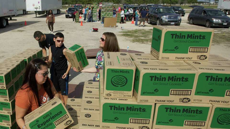 Volunteers organize boxes of the famous Thin Mints Girl Scout Cookies during Saturday's Girl Scout Cookie Drop at the Sam Houston Race Park. Over 400,000 boxes of the famous cookies were distributed to area troops.