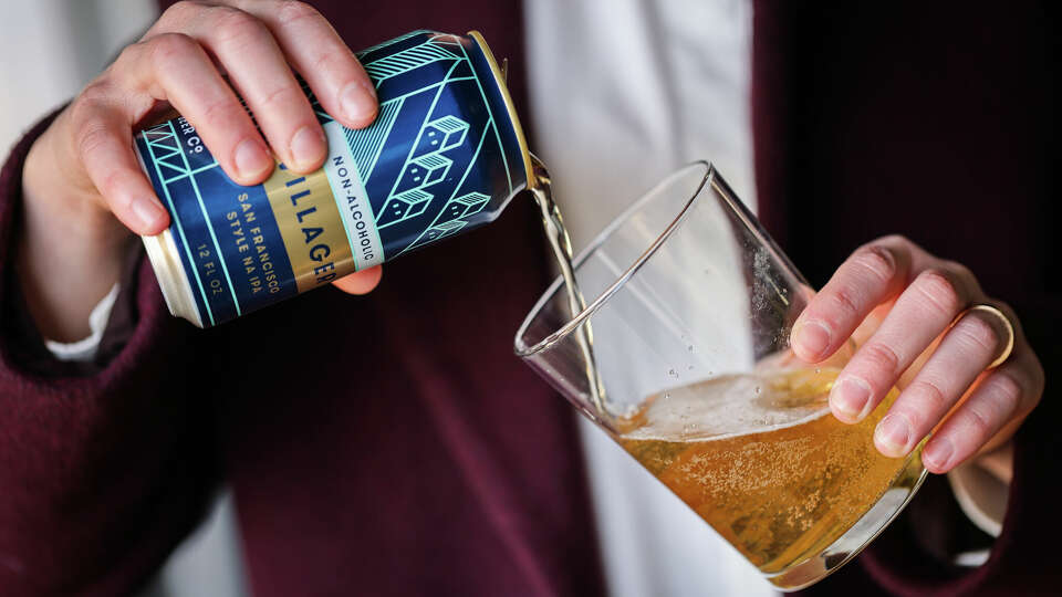 Dina Dobkin, Chief Brand Officer and co-owner of Fort Point Beer Company, pours a non- alcoholic beer during an interview by the Chronicle about their new non- alcoholic beer in the Presidio in San Francisco on Monday, Dec. 30, 2024.