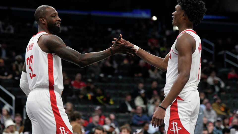 Houston Rockets forwards Jeff Green (32) and Amen Thompson (1) high five after scoring against the Washington Wizards during the first half of an NBA basketball game Tuesday, Jan. 7, 2025, in Washington. (AP Photo/Jess Rapfogel)