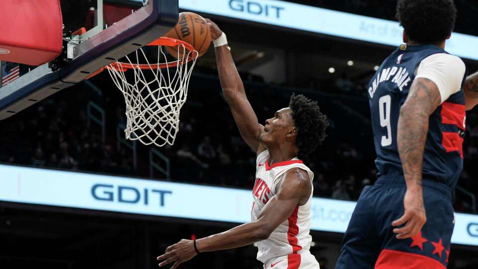 Houston Rockets forward Amen Thompson (1) dunks against Washington Wizards forward Justin Champagne (9) during the first half of an NBA basketball game Tuesday, Jan. 7, 2025, in Washington. (AP Photo/Jess Rapfogel)