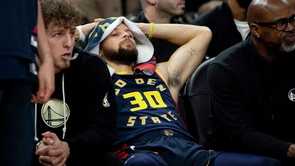 Golden State Warriors guard Stephen Curry (30) is seen on the bench during the second half of his NBA basketball game against the Miami Heat in San Francisco, Tuesday, Jan. 7, 2025. The Heat defeated the Wariors 114-98.