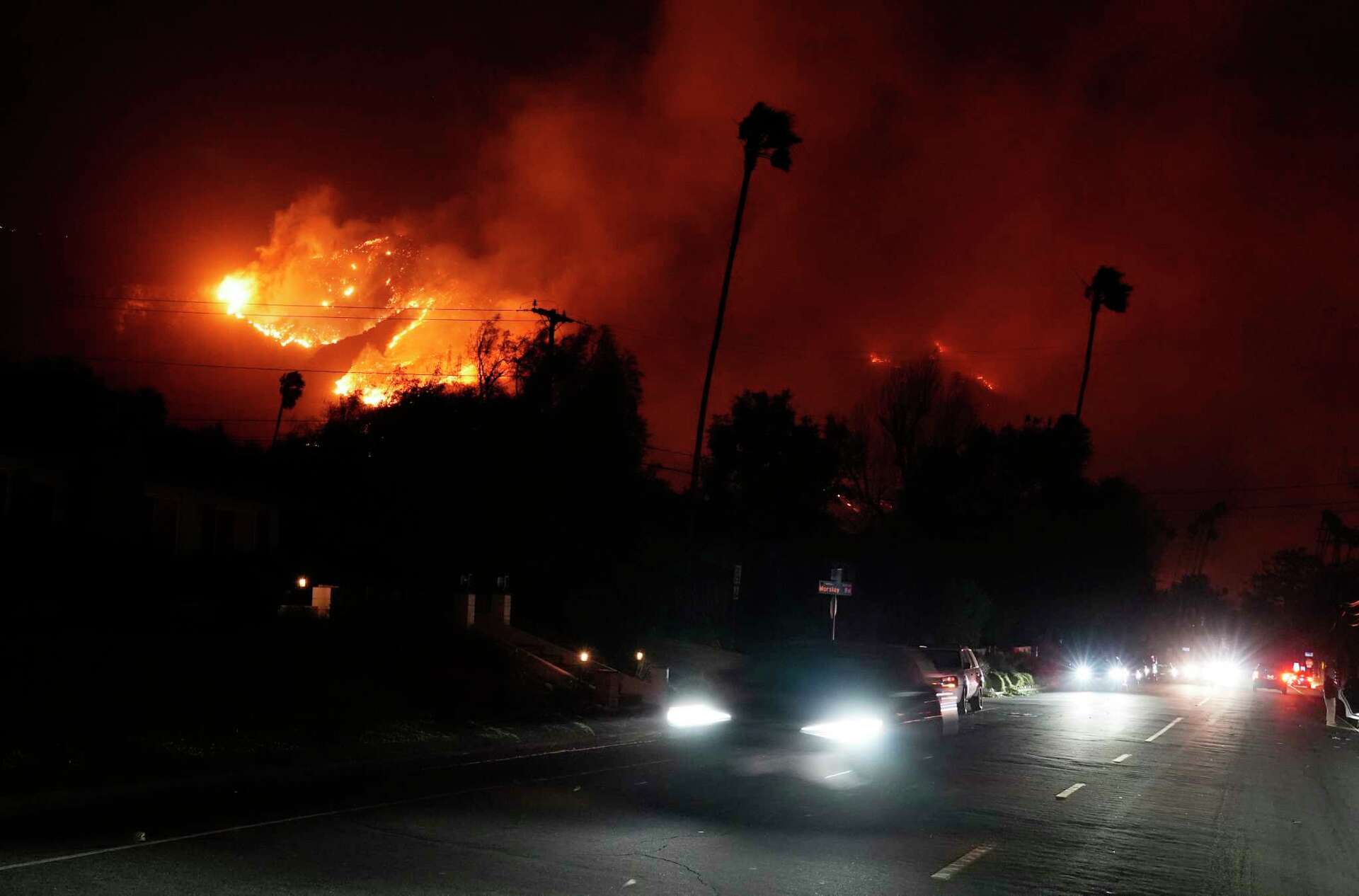 Wildfires latest Thousands flee Los Angeles as blazes burn in and