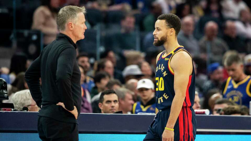 Golden State Warriors guard Stephen Curry (30) and Head Coach Steve Kerr are seen on the sideline during the first half of their NBA basketball game against the Miami Heat in San Francisco, Tuesday, Jan. 7, 2025.