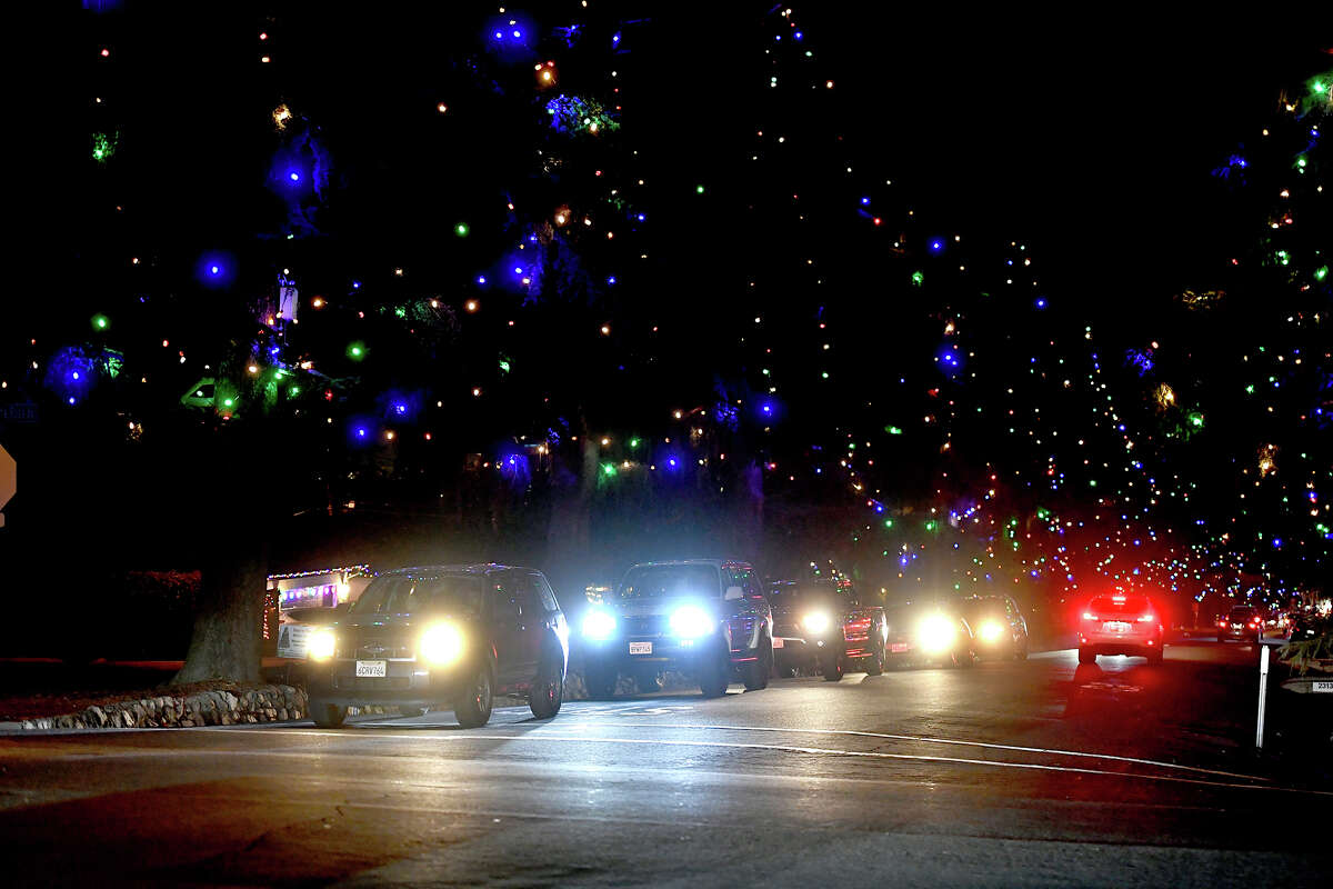 Cars drive along Christmas Tree Lane on December 18, 2020 in Altadena, California