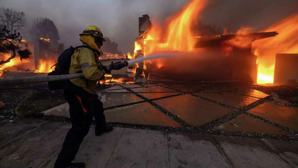 Firefighters battle the Palisades fire on El Medio Ave. in Pacific Palisades, Jan 7, 2025..