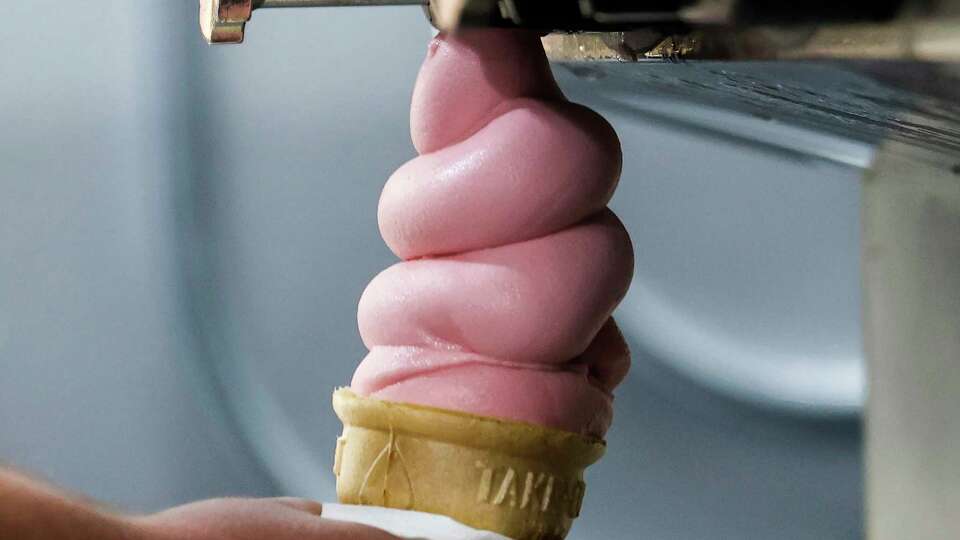 Adam Marks makes a strawberry soft serve cone at Meadowlark Dairy in Pleasanton, Calif. Tuesday, Aug. 29, 2023.