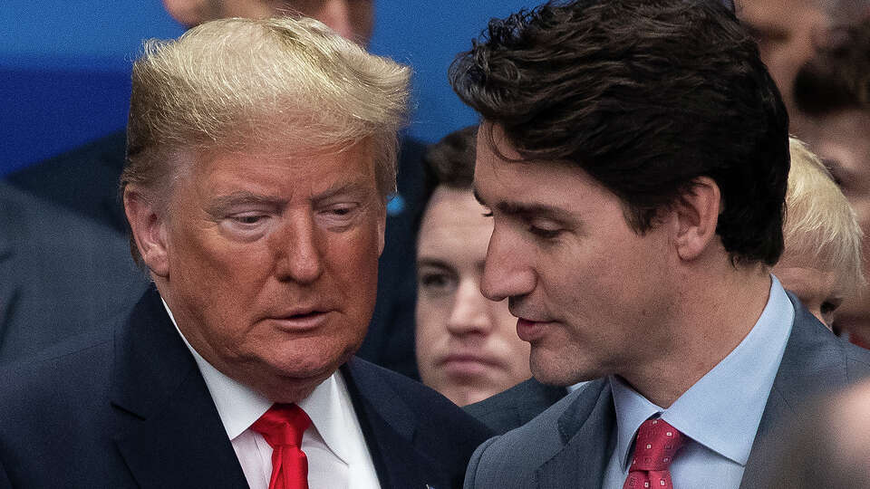 Then-U.S. President Donald Trump and Canadian Prime Minister Justin Trudeau attend the NATO summit at the Grove Hotel on Dec. 4, 2019, in Watford, England.