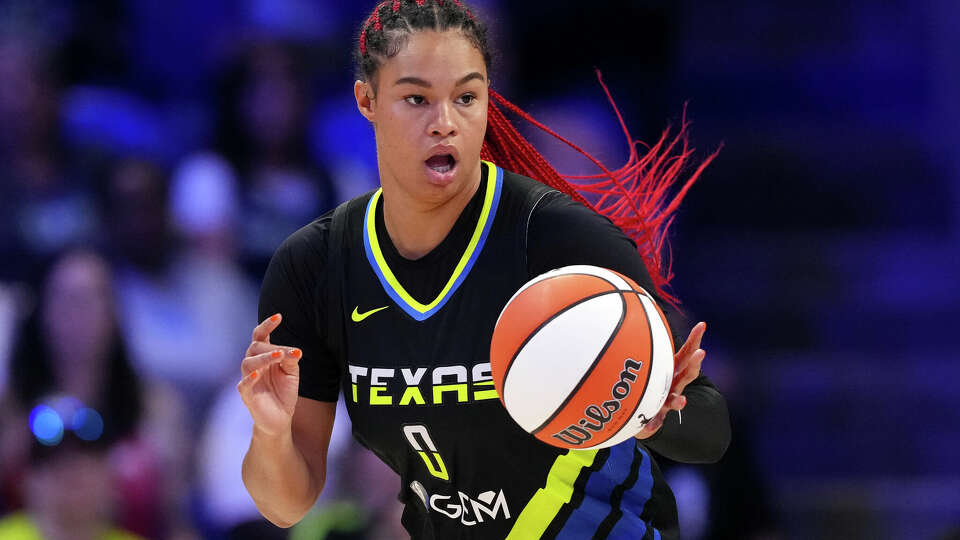 Satou Sabally #0 of the Dallas Wings controls the ball during the first half against the Seattle Storm at College Park Center on September 13, 2024 in Arlington, Texas. 