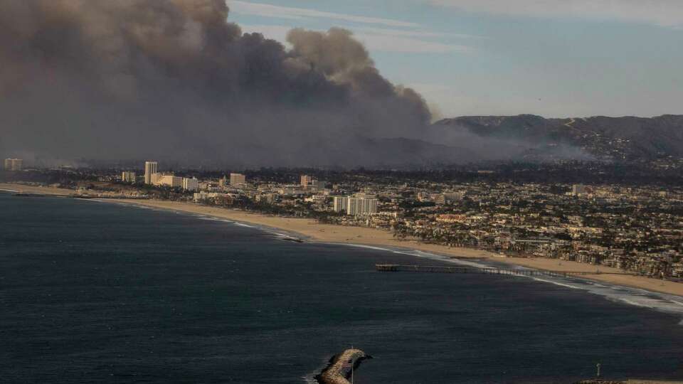 Smoke from the Palisades Fire is seen during a commercial flight to Los Angeles, Calif., Wednesday Jan. 8, 2025