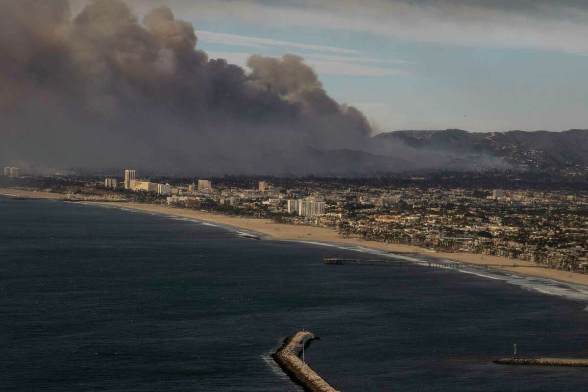 Smoke from the Palisades Fire is seen during a commercial flight to Los Angeles, Calif., Wednesday Jan. 8, 2025